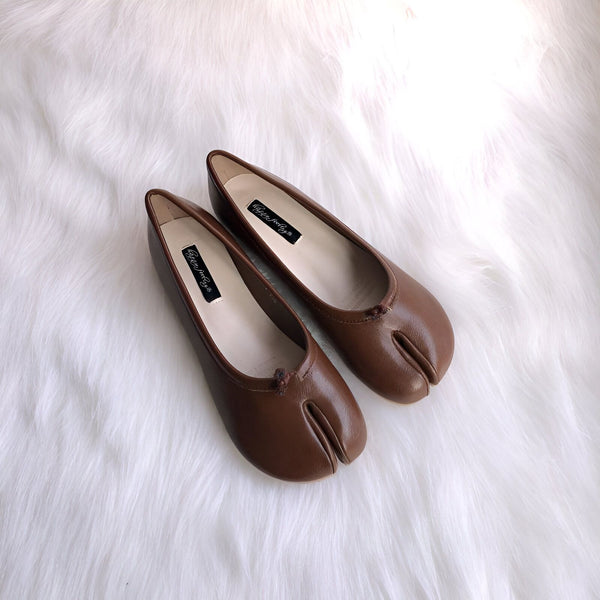 Deux ballerines tabi marron sur une surface blanche duveteuse. Ces chaussures japonaises distinctives ont une séparation pour le gros orteil. Chaussures tendance et confortables., 45286633865397,45286633898165,45286633930933,45286633963701,45286633996469,45286634029237,45286634062005,45286634094773,45286634127541,45286634160309,45286634193077,45286634225845,45286634258613,45286634291381,45286634324149,45286634356917,45286634389685,45286634422453,45286634455221,45286634487989,45286634520757,45286634553525