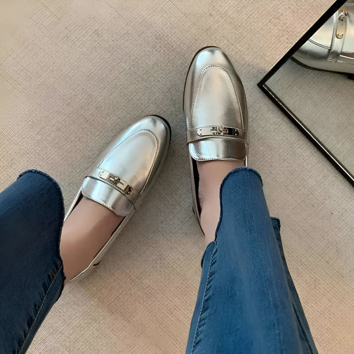 Vue de dessus d'une femme portant des mocassins argentés avec des jeans bleus clairs. On voit un miroir reflétant une autre chaussure argentée., 45286708412597,45286708445365,45286708478133,45286708510901,45286708543669