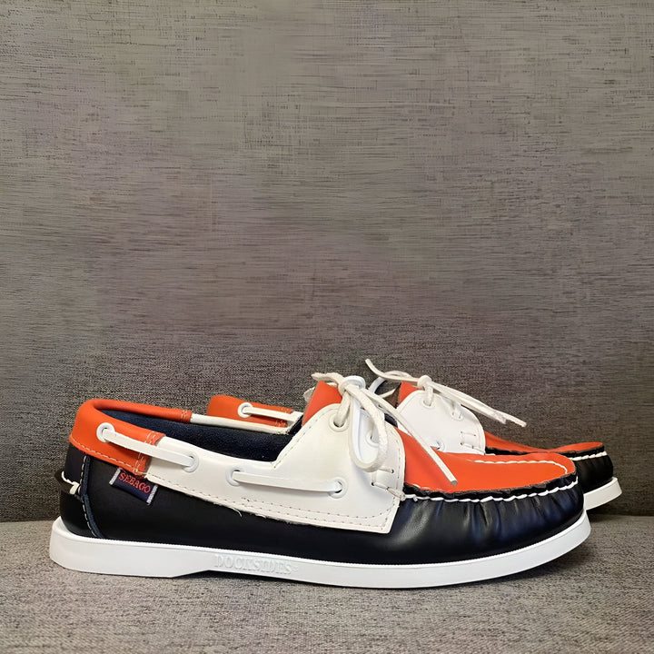 Vue rapprochée de deux chaussures bateau Sebago Docksides tricolores (noir, blanc et orange) avec des lacets blancs, posées sur un fond gris., 45286755401909,45286755434677,45286755467445,45286755500213,45286755532981,45286755565749,45286755598517,45286755631285,45286755664053,45286755696821,45286755729589,45286755762357,45286755795125,45286755827893,45286755860661,45286755893429,45286755926197,45286755958965,45286755991733,45286756024501,45286756057269,45286756090037,45286756122805,45286756155573,45286