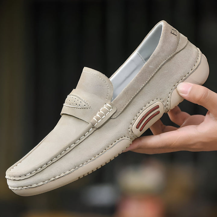 Mocassin beige en cuir suédé pour homme, tenu à la main. Chaussure décontractée élégante, détails soignés et couture apparente. Mode masculine, confort et style., 45286806192309,45286806225077,45286806257845,45286806290613,45286806323381,45286806356149,45286806388917,45286806421685