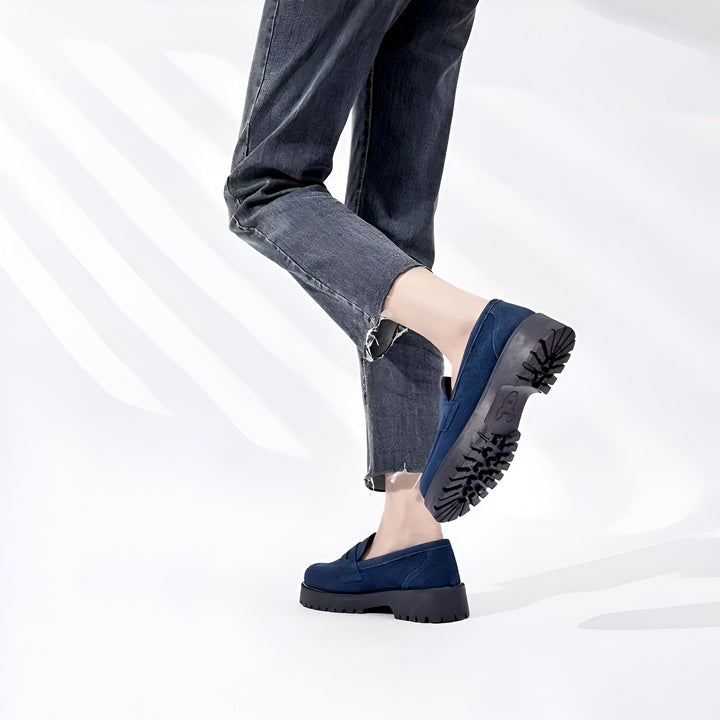 Gros plan des pieds d'une personne portant des mocassins bleus à semelles épaisses avec un jean gris foncé, sur fond blanc. Chaussures confortables et stylées., 45286919241909,45286919274677,45286919307445,45286919340213,45286919372981,45286919405749,45286919438517,45286919471285,45286919504053,45286919536821,45286919569589,45286919602357,45286919635125,45286919667893,45286919700661,45286919733429,45286919766197,45286919798965,45286919831733,45286919864501,45286919897269,45286919930037,45286919962805,