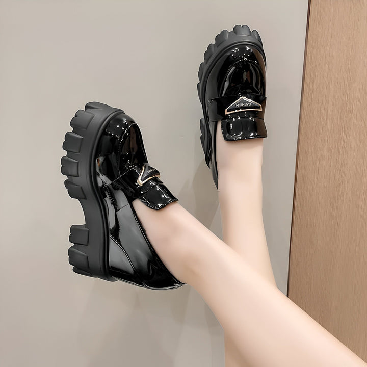 Gros plan sur une paire de mocassins noirs vernis à semelles compensées portés par une femme. Chaussures tendance et stylées., 45286905938101,45286905970869,45286906003637,45286906036405,45286906069173,45286906101941,45286906134709,45286906167477,45286906200245,45286906233013,45286906265781,45286906298549