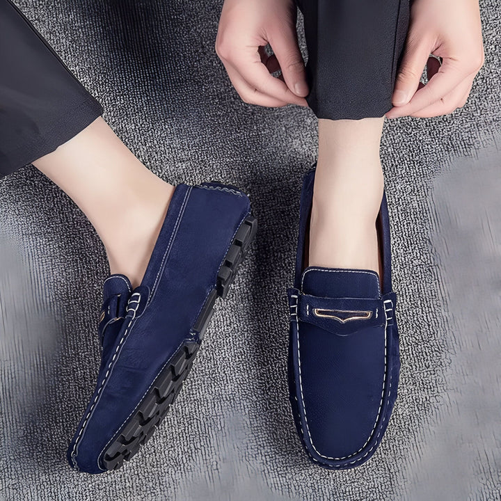 Mocassins pour hommes en daim bleu marine, portés avec un pantalon noir. Détails de couture blanche. Semelle noire antidérapante., 45286659686581,45286659719349,45286659752117,45286659784885,45286659817653,45286659850421,45286659883189,45286659915957,45286659948725,45286659981493,45286660014261,45286660047029,45286660079797,45286660112565,45286660145333,45286660178101,45286660210869,45286660243637,45286660276405,45286660309173,45286660341941,45286660374709,45286660407477,45286660440245,45286660473013,4