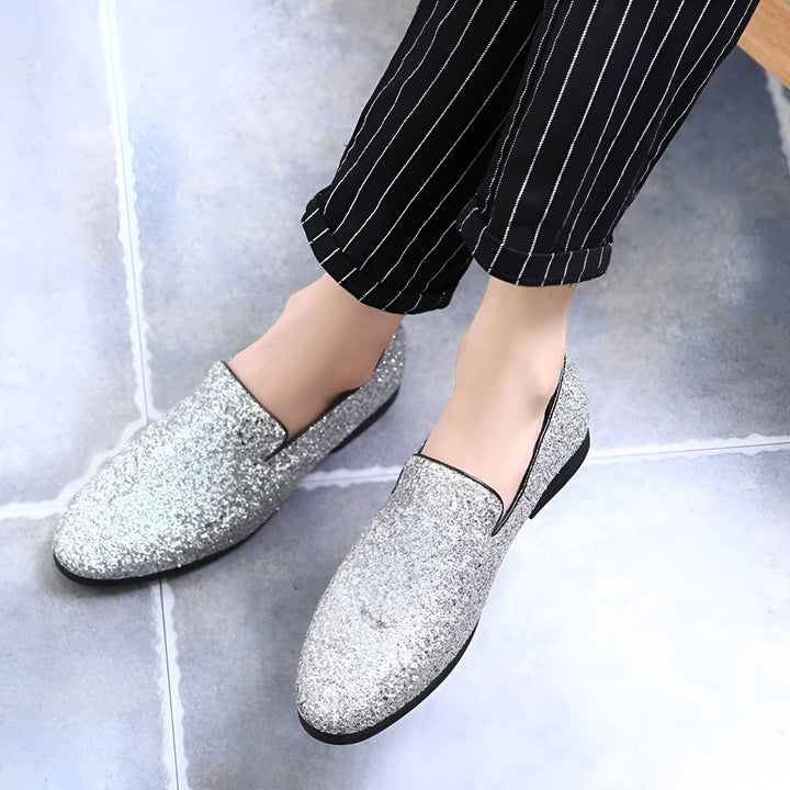 Personne portant des mocassins argentés à paillettes avec un pantalon rayé noir et blanc. Chaussures élégantes et brillantes pour une occasion spéciale., 45286638649525,45286638682293,45286638715061,45286638747829,45286638780597,45286638813365,45286638846133,45286638878901,45286638911669,45286638944437,45286638977205,45286639009973,45286639042741,45286639075509,45286639108277,45286639141045,45286639173813,45286639206581,45286639239349,45286639272117,45286639304885,45286639337653,45286639370421,45286