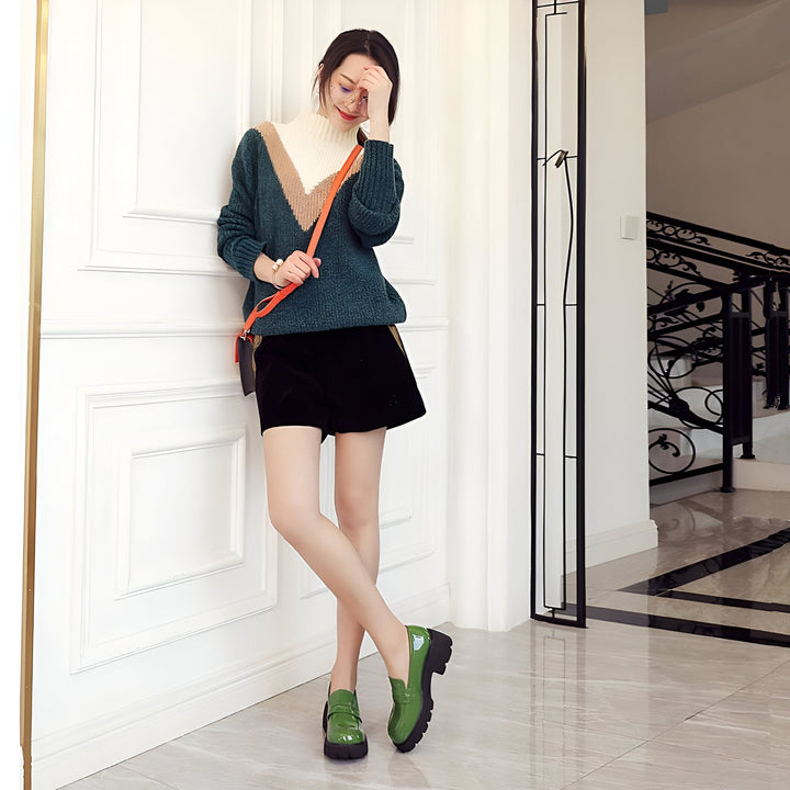 Jeune femme souriante en pull vert à col roulé, short noir et chaussures vernies vertes, posant près d'une porte blanche avec une balustrade d'escalier en arrière-plan. Mode automne-hiver., 45286916948149,45286916980917,45286917013685,45286917046453,45286917079221,45286917111989,45286917144757,45286917177525,45286917210293,45286917243061,45286917275829,45286917308597,45286917341365,45286917374133,45286917406901,45286917439669,45286917472437,45286917505205,45286917537973,45286917570741,45286917603509,4