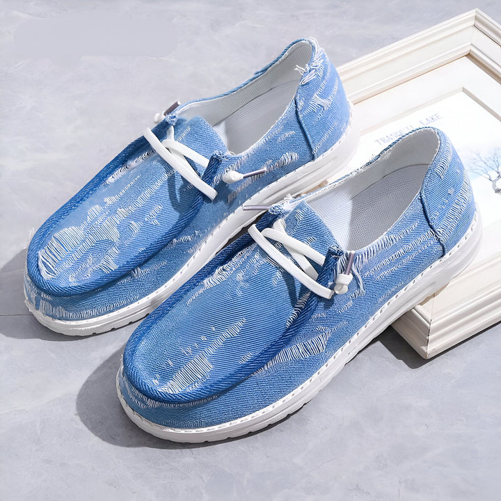 Deux mocassins en toile bleue avec des lacets blancs reposant sur une surface grise et près d'un cadre blanc. Ces chaussures décontractées sont parfaites pour l'été., 45286736789685,45286736822453,45286736855221,45286736887989,45286736920757,45286736953525,45286736986293,45286737019061,45286737051829