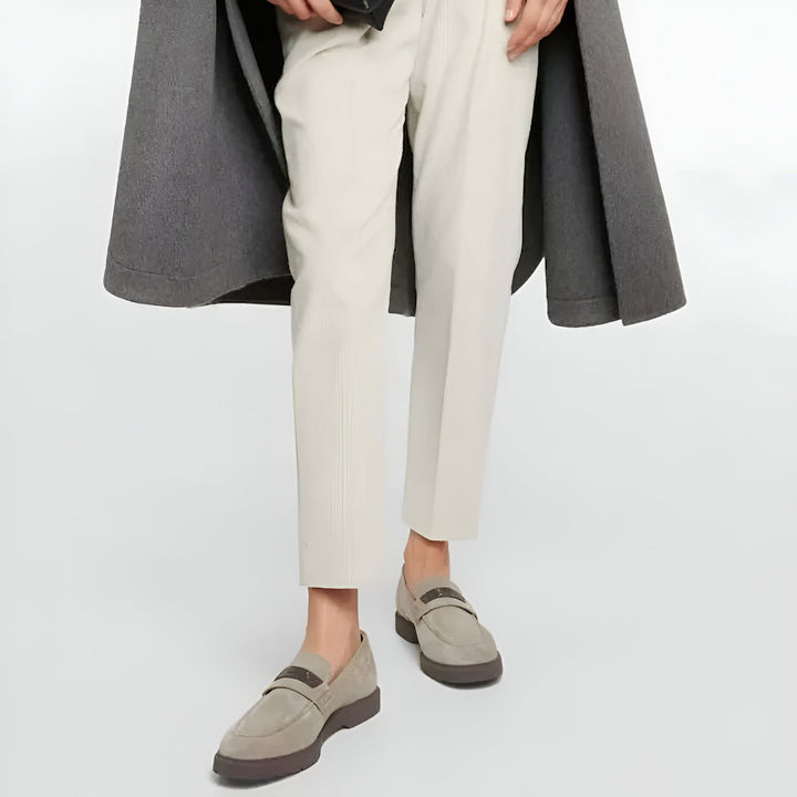Gros plan sur une tenue élégante : un pantalon crème à fines rayures, des mocassins en daim gris-beige avec une bande marron, et un manteau gris porté en cape. Look décontracté chic., 45286718046389,45286718079157,45286718111925,45286718144693,45286718177461,45286718210229