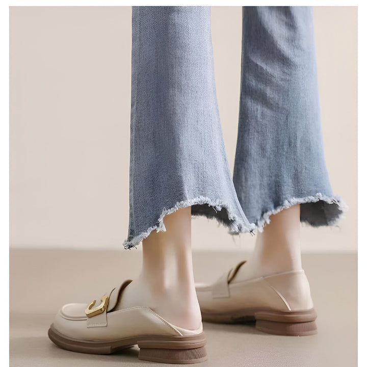 Gros plan sur une femme portant des mocassins beiges à boucle dorée et un jean évasé. Style décontracté et élégant. Chaussures tendance pour femmes., 45286718767285,45286718800053,45286718832821,45286718865589,45286718898357,45286718931125,45286718963893,45286718996661,45286719029429,45286719062197,45286719094965,45286719127733,45286719160501,45286719193269,45286719226037,45286719258805,45286719291573,45286719324341,45286719357109,45286719389877