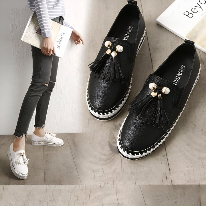 Chaussures plates pour femmes avec détails décoratifs. Sur l'image, des mocassins noirs et blancs, portés avec un jean et un pull rayé, ainsi qu'une paire de chaussures similaires posées à plat. Style décontracté et élégant., 45286766313653,45286766346421,45286766379189,45286766411957,45286766444725,45286766477493,45286766510261,45286766543029,45286766575797,45286766608565,45286766641333,45286766674101