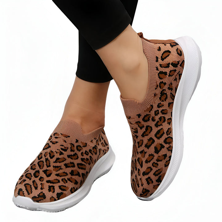 Femme portant des baskets slip-on à motif léopard marron avec semelle blanche. Chaussures décontractées et tendance., 45287151501493,45287151534261,45287151567029,45287151599797,45287151632565,45287151665333,45287151698101,45287151730869