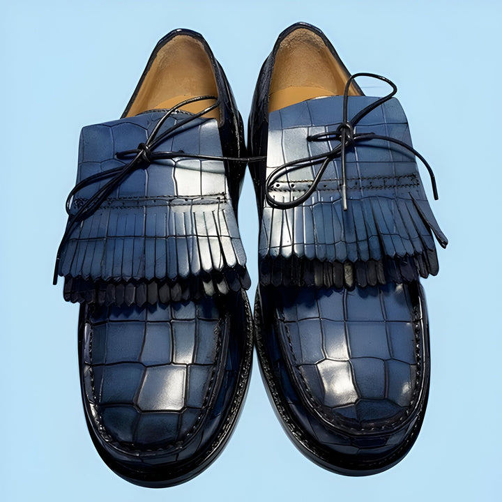 Deux mocassins bleus en cuir texturé avec des franges et des lacets fins sur fond bleu clair. Chaussures de mode pour hommes ou femmes, style élégant., 45286844170421,45286844203189,45286844235957,45286844268725,45286844301493,45286844334261,45286844367029,45286844399797,45286844432565,45286844465333,45286844498101,45286844530869,45286844563637,45286844596405,45286844629173,45286844661941