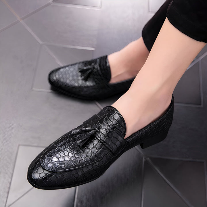 Gros plan de mocassins noirs à glands avec motif peau de crocodile. Chaussures élégantes portées par un homme, idéales pour un look habillé et moderne. Mode masculine, souliers en cuir., 45287059423413,45287059456181,45287059488949,45287059521717,45287059554485,45287059587253,45287059620021,45287059652789,45287059685557,45287059718325,45287059751093,45287059783861,45287059816629,45287059849397,45287059882165,45287059914933,45287059947701,45287059980469,45287060013237,45287060046005,45287060078773,45